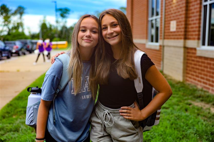 Two people smile on the first day of school